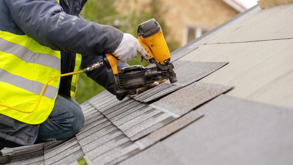 Commercial Roofing Contractor - Roofer installing shingles on a roof