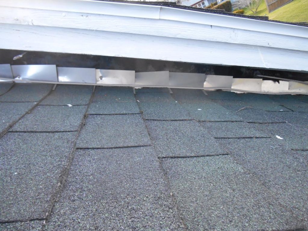 roof flashing repair - close up image of step flashing on a roof
